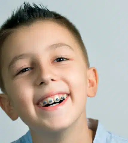 Smiling child wearing braces in Simsbury