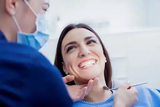 Woman smiling with her orthodontist during an Invisalign appointment