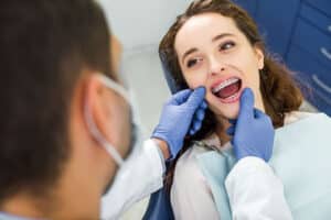 Orthodontist explaining braces options to a patient