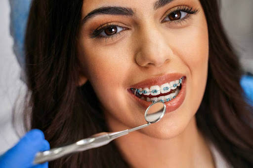 Orthodontist examining braces treatment and smile, planning for early removal before events.